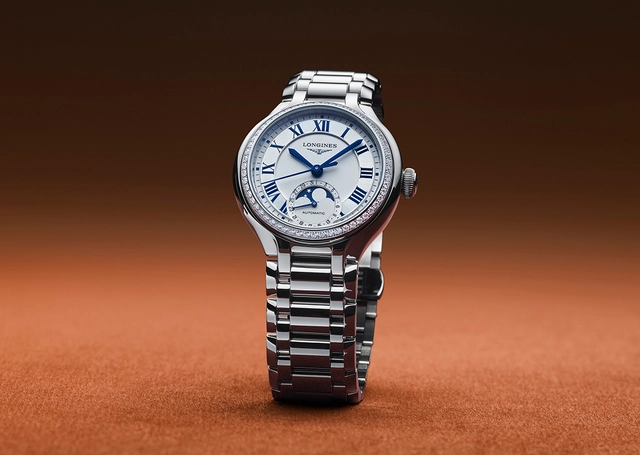 Longines PrimaLuna, Referenz L8.126.0.71.6, Stahlversion vor farbigem Hintergrund