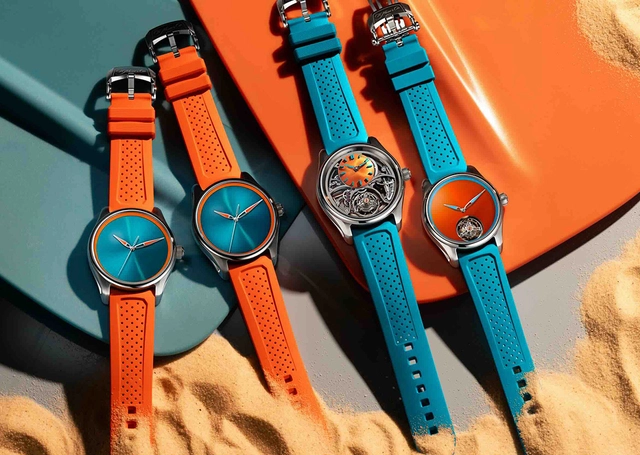 H. Moser & Cie. Pioneer Spiced Aqua, drei Uhren mit Taucherflossen im Hintergrund
