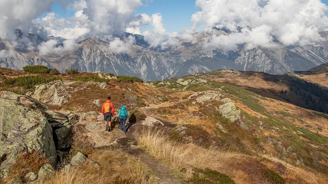 Zwei Wandernde vor Bergpanorama im Montafon.