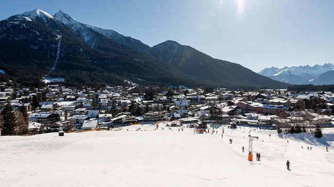Blick auf Bergkulisse und eine Skipiste in der Region Seefeld.
