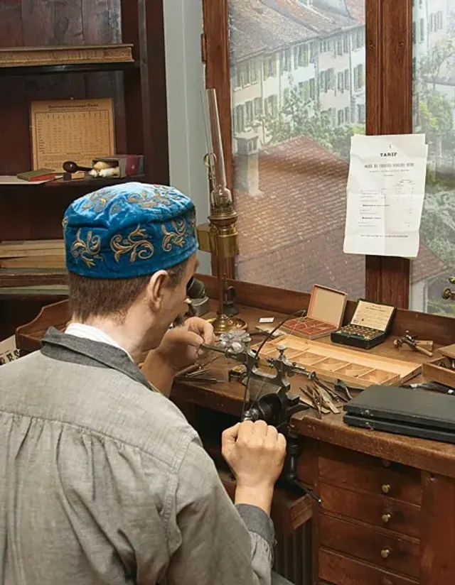 Uhrmacher_an_Werkbank_1875