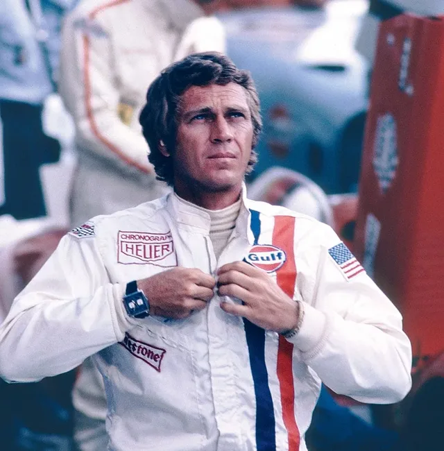 Steve McQueen mit der Monaco am Arm und dem Heuer-Logo auf dem Anzug im Film "Le Mans"