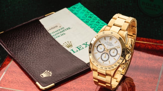 Zertifikat und goldene Rolex Daytona Front